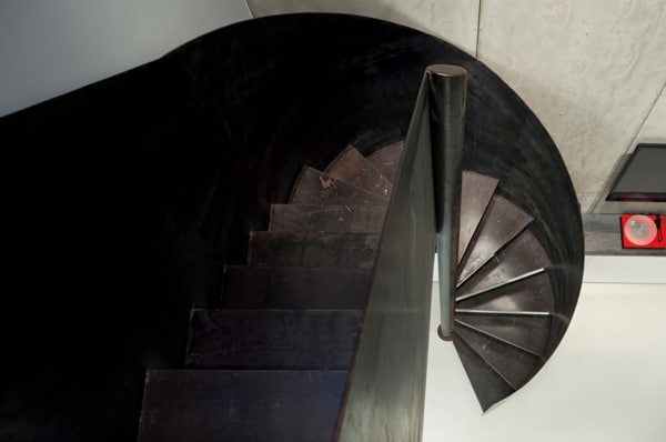 Modern apartment with a sleek sculptural staircase